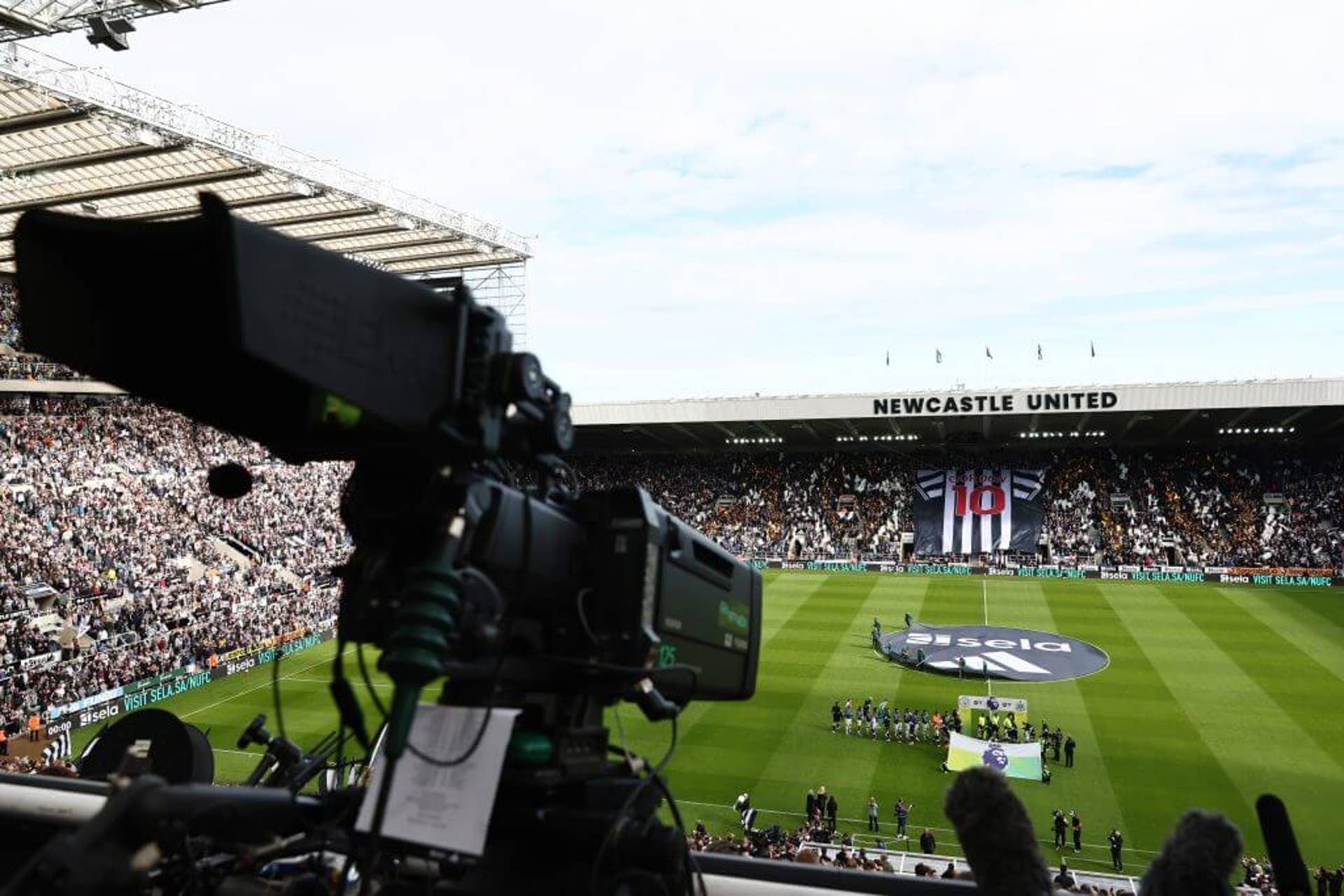 A broadcast camera pointing down at the St James' Park pitch