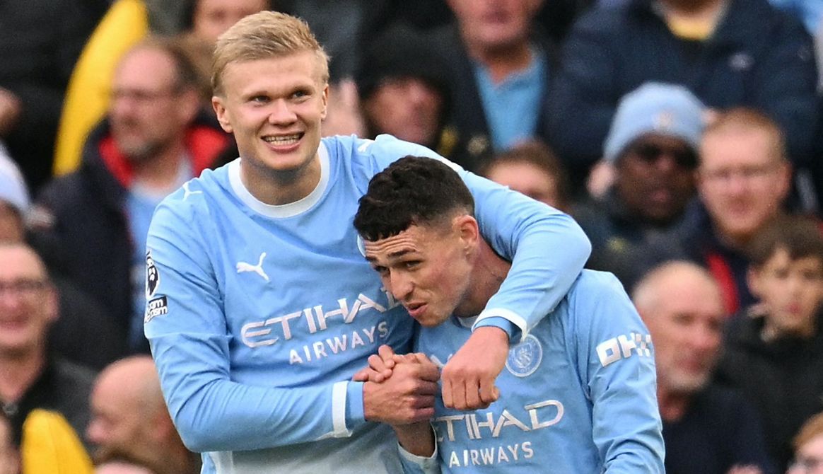 Erling Haaland hugs Phil Foden, Man City