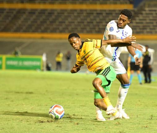 Jamaica’s Dwayne Atkinson (left) turns away from Alenis Vargas of Honduras during the Concacaf Nations League match at the National Stadium on September 28, 2026. Honduras won 1-0.